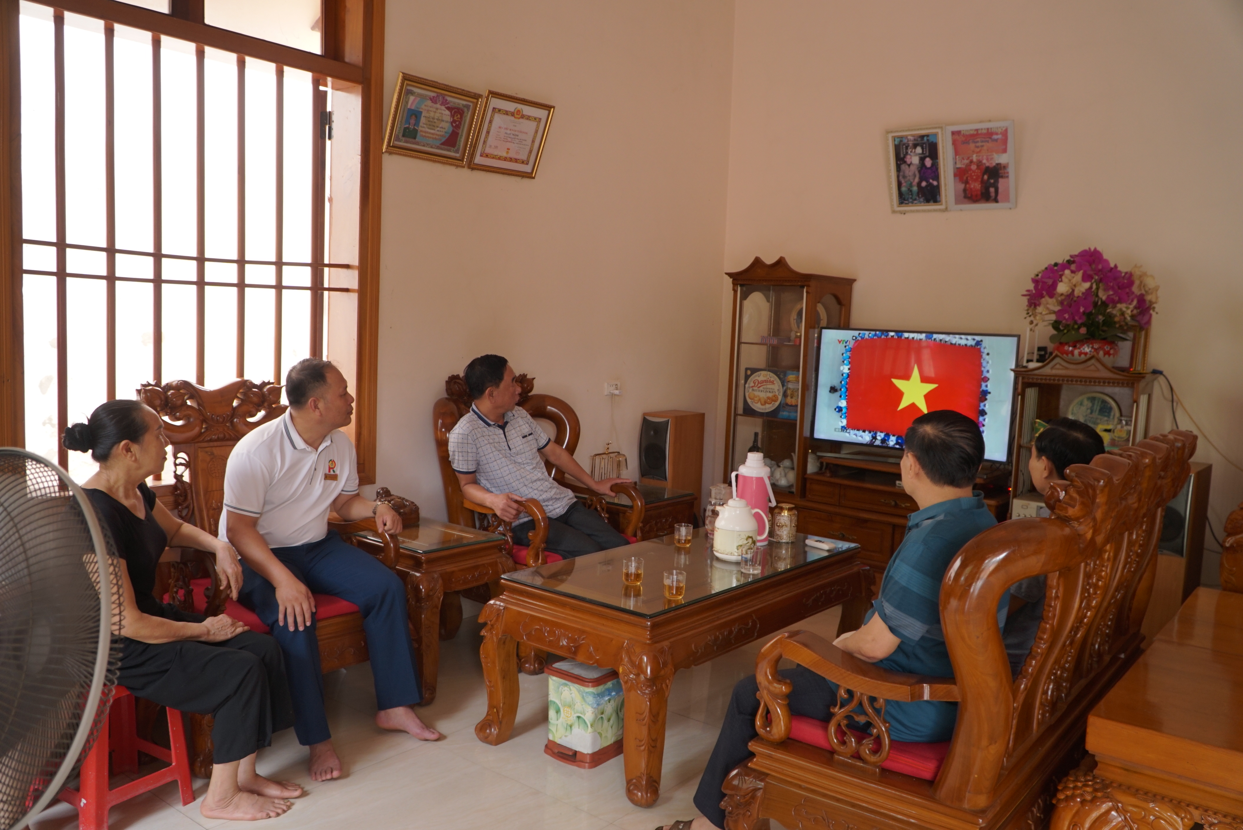 Gia đình ông Lê Thành theo dõi lễ kỷ niệm Chiến thắng Điện Biên Phủ.